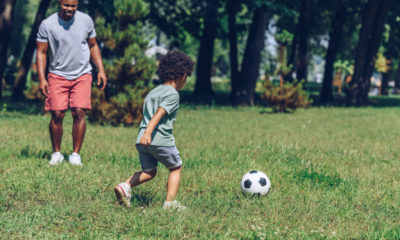 Dad Plays Soccer With His Son During Summer Visitation.