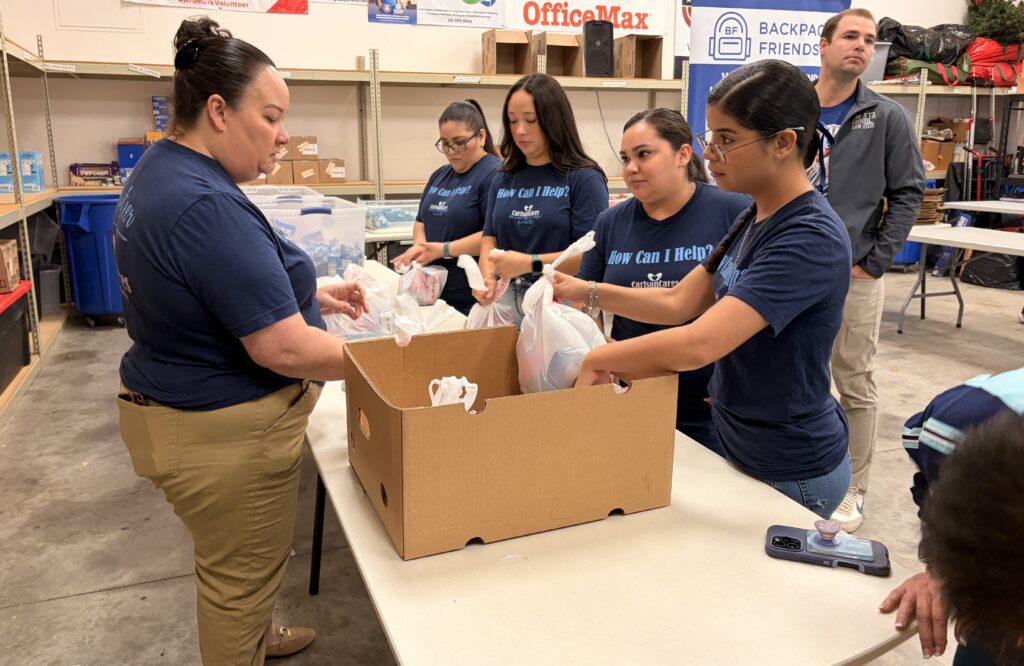 Carlson Cares volunteers helping Backpack Friends on National Superhero Day.
