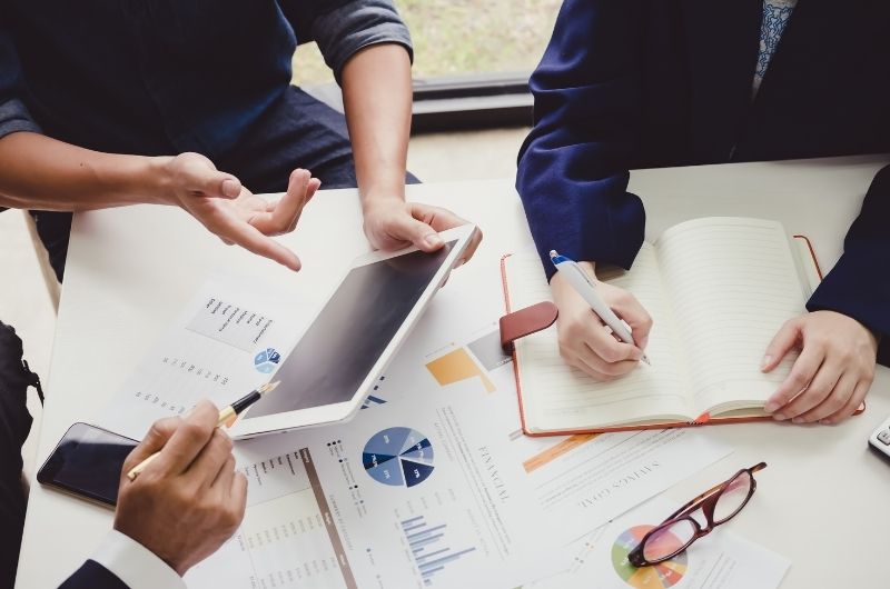Couple reviewing financial documents related to business ownership, investments and property division during a high-asset divorce.