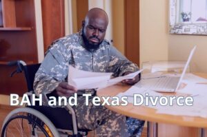 Military service member reviewing financial documents related to housing allowances and child support during a Texas divorce.