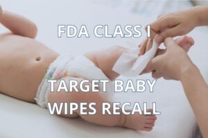 Caregiver using a baby wipe on an infant representing the Target Up & Up baby wipes recall.