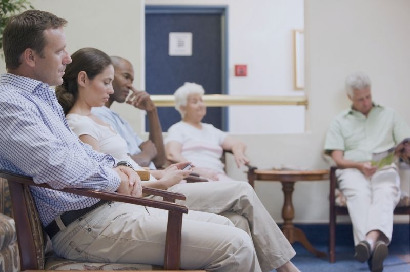 Patient sitting in a medical office reflecting on a healthcare experience.