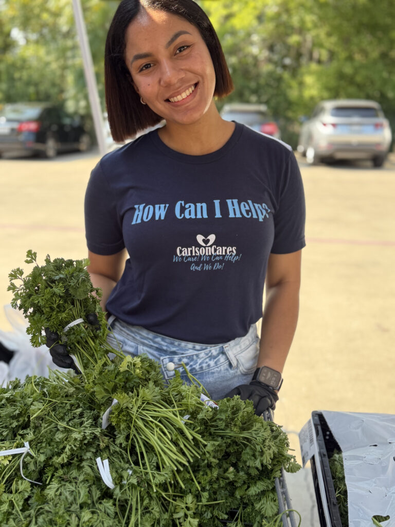 Carlson Cares volunteer preparing fresh produce at the Killeen Food Care Center.