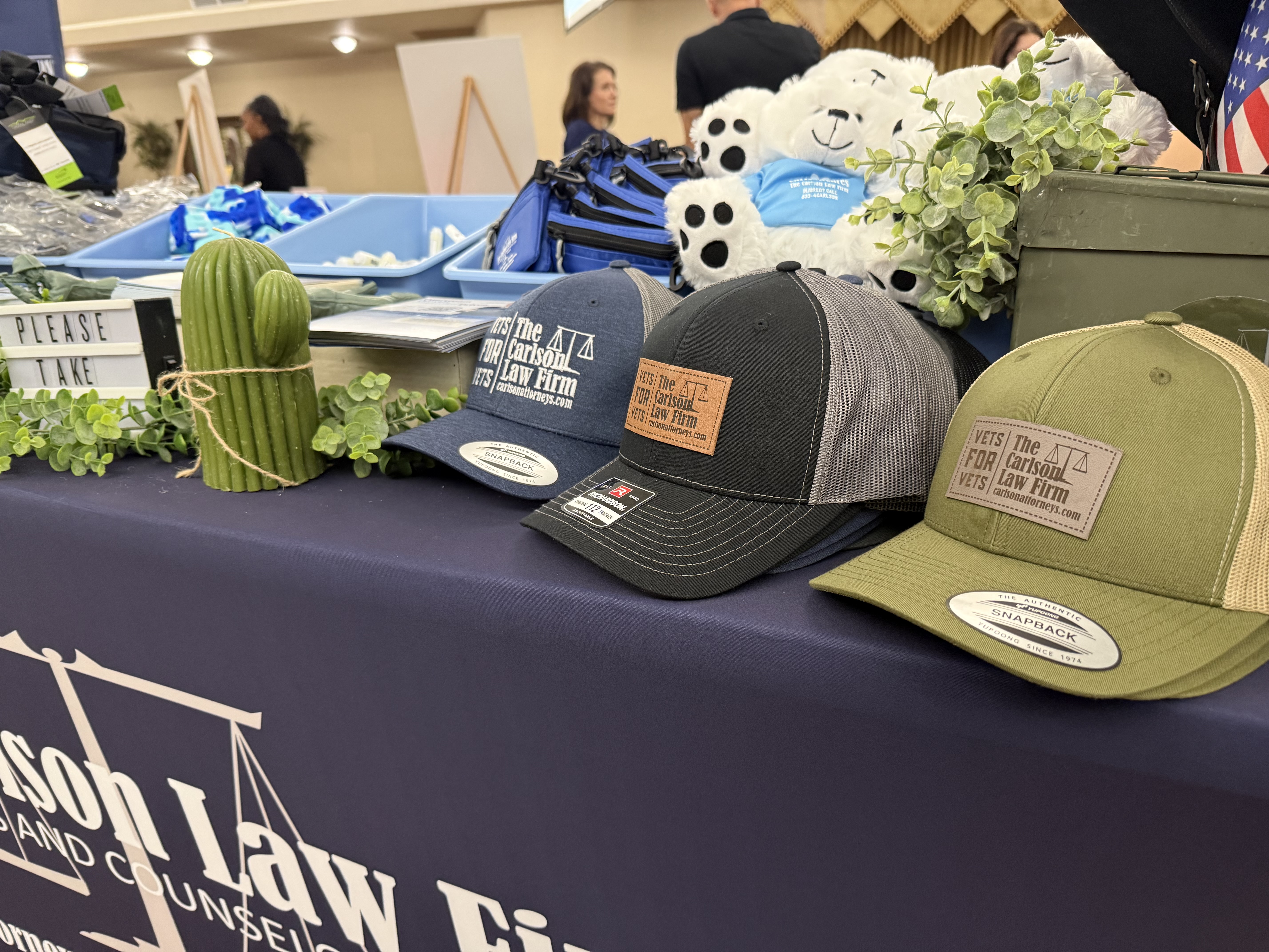 The Carlson Law Firm Vets for Vets hats displayed at Hood Howdy 2026.