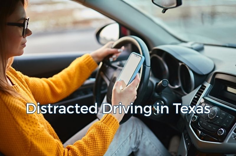 Driver using a cell phone while operating a vehicle in Texas traffic.