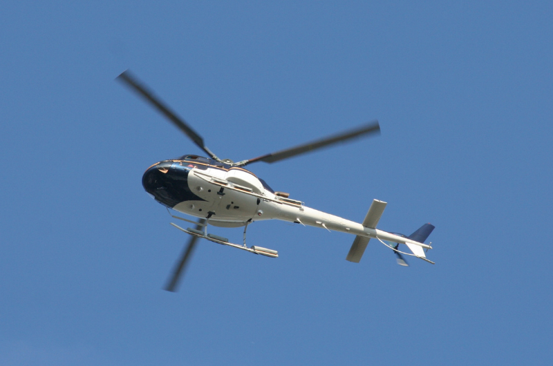 Helicopter flying against a clear blue sky