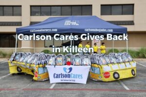 Children and families receive backpacks and school supplies during the 2026 Carlson Cares Killeen Backpack Giveaway.