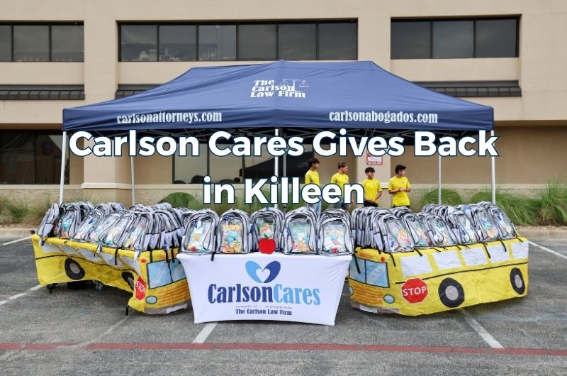 Children and families receive backpacks and school supplies during the 2026 Carlson Cares Killeen Backpack Giveaway.