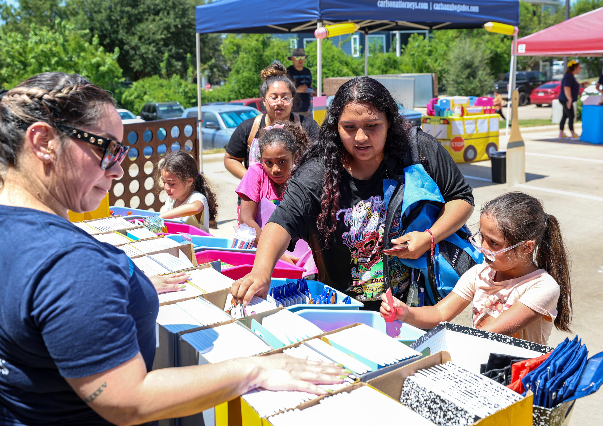 Students select free school supplies during the Carlson Cares San Marcos Backpack Giveaway.
