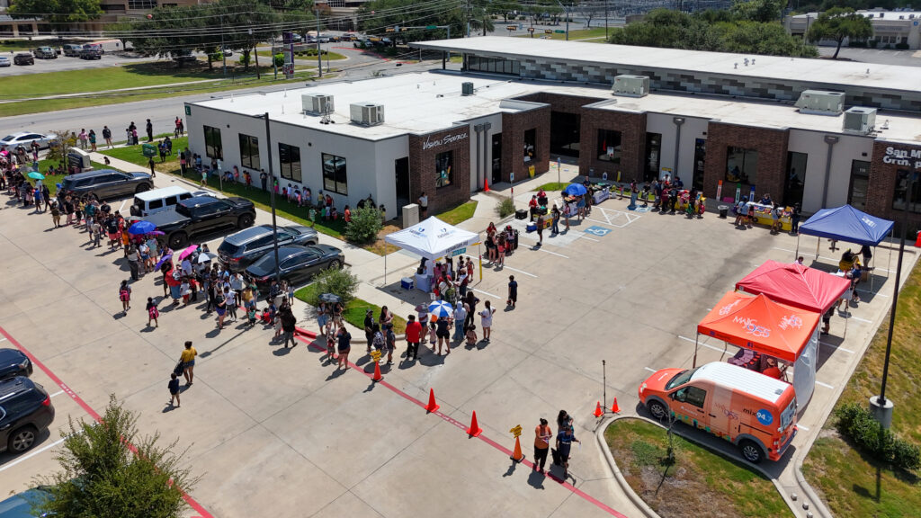 Aerial view of families attending the Carlson Cares San Marcos Backpack Giveaway.