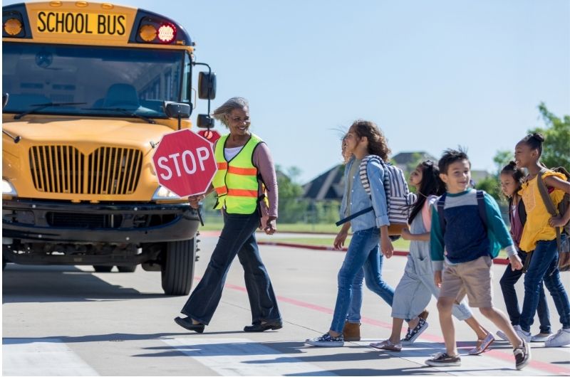 Children crossing a school crossing near a construction zone.