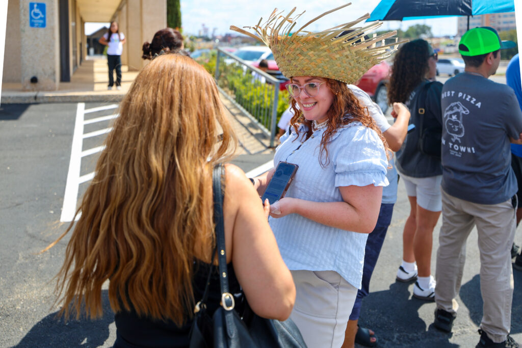 The Carlson Law Firm staff member visiting with an attendee during the Temple Hispanic Heritage Month celebration.