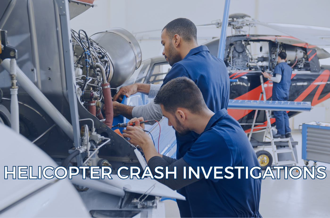 Technicians inspecting helicopter components inside an aircraft hangar.