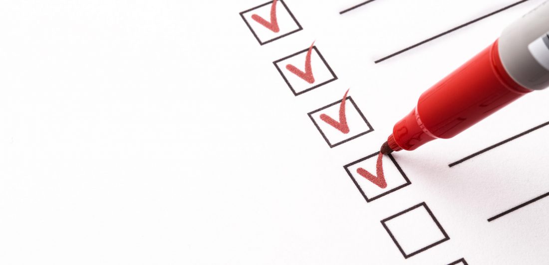 Checklist with pencil Image of a red marker making checks in boxes on a piece of paper