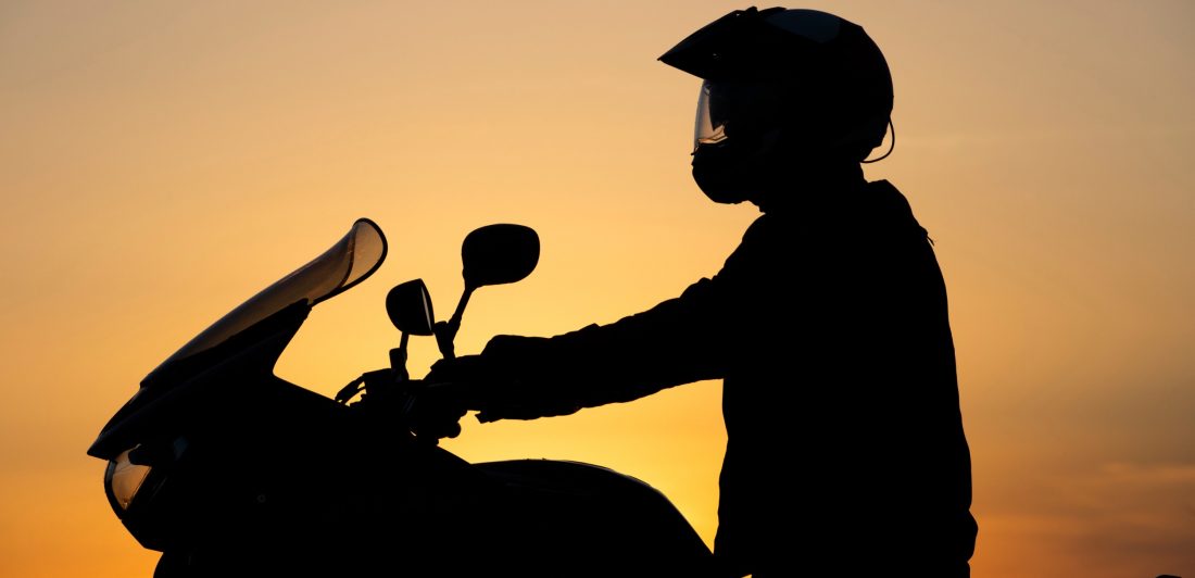 157517985_m_normal_none Silhouette of person on motorcycle at sunset