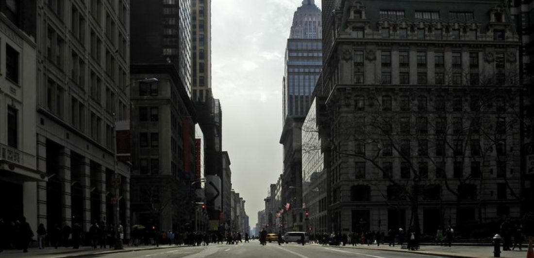 Image of city street surrounded by tall buildings