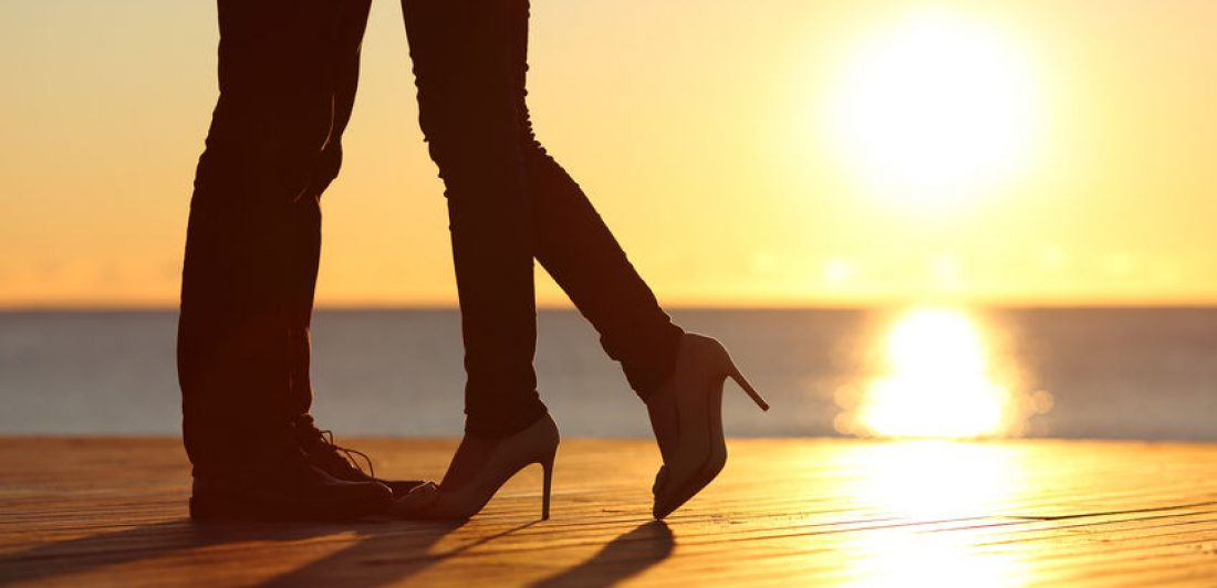 Couple legs falling in love hugging at sunset Image of silhouette of couple's legs at sunset
