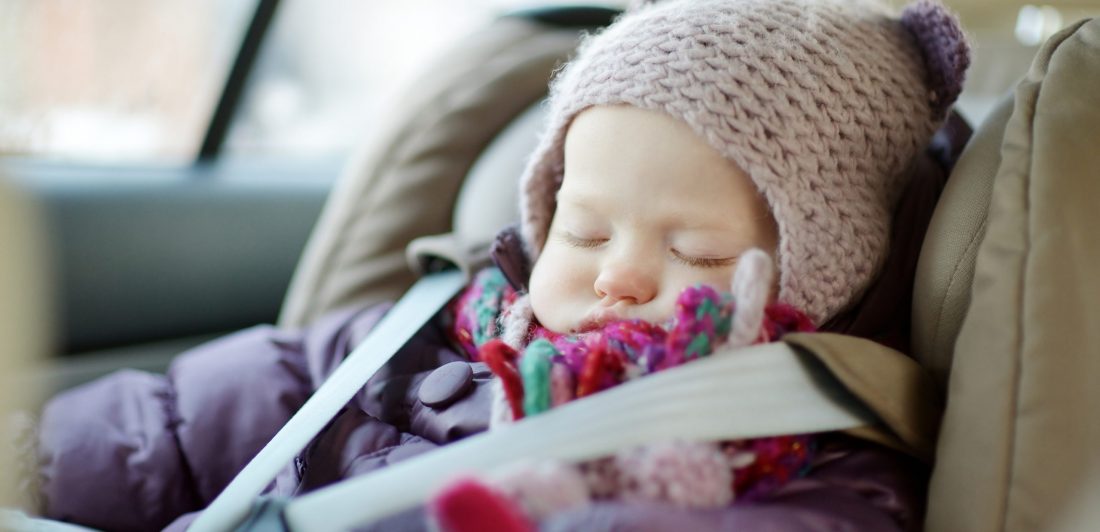 Sweet toddler girl sleeping in a car seat Image of sleeping toddler in winter coat in car seat