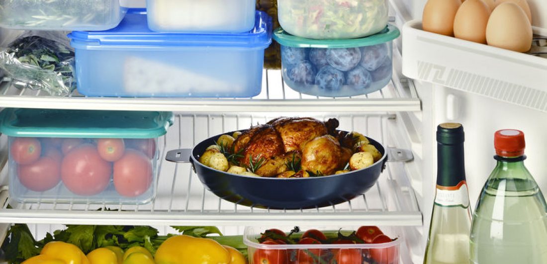Image of the inside of a refrigerator with food in plastic storage containers