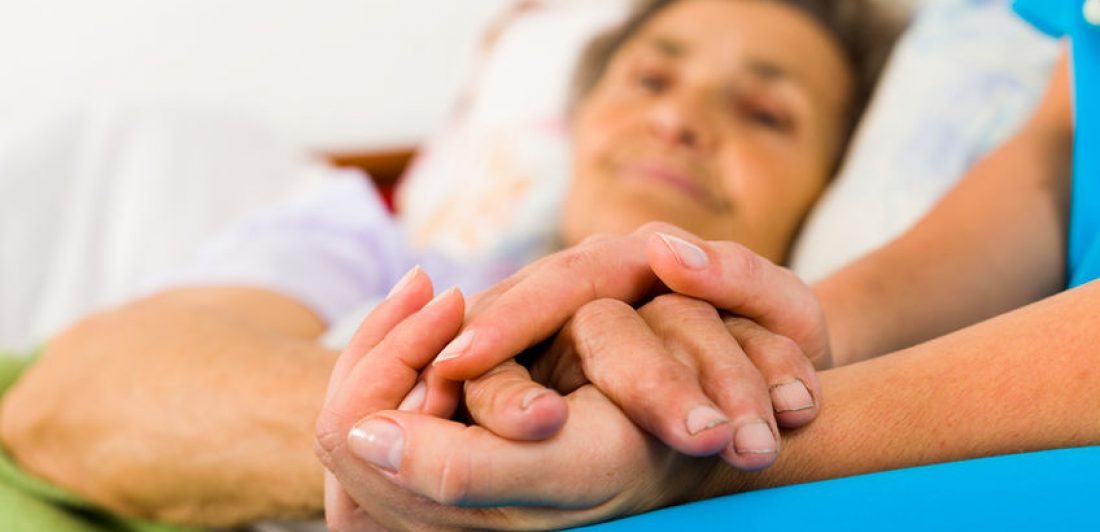 Caring Nurse Holding Hands Image of medical professional holding an elderly person's hand