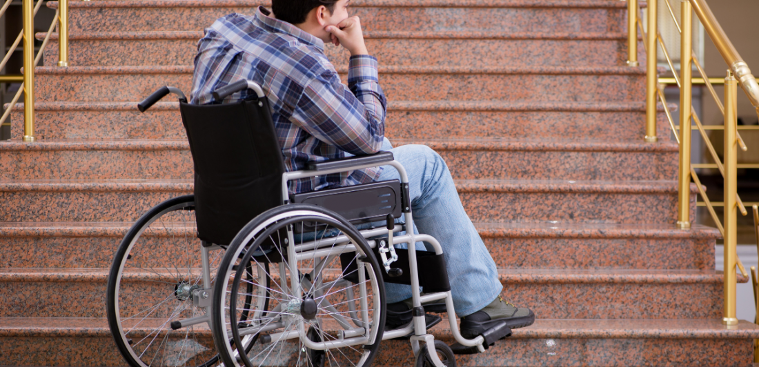 ADA Image of person in wheelchair at the bottom of stairs