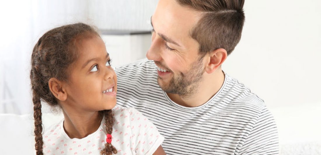 Happy father with cute African American daughter Image of happy dad and daughter