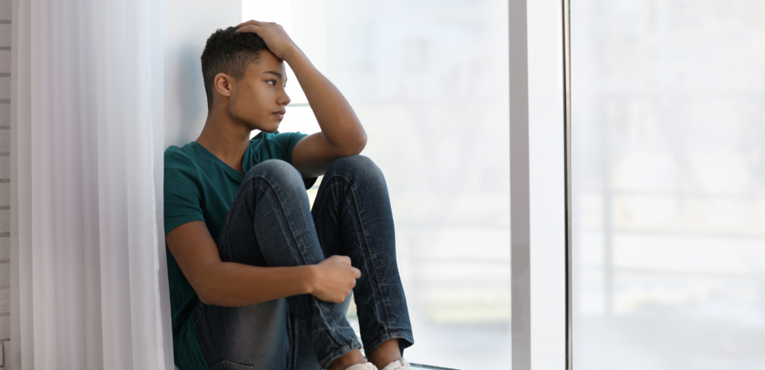 Clergy-abuse-option-2 Image of person looking sad, sitting by a window