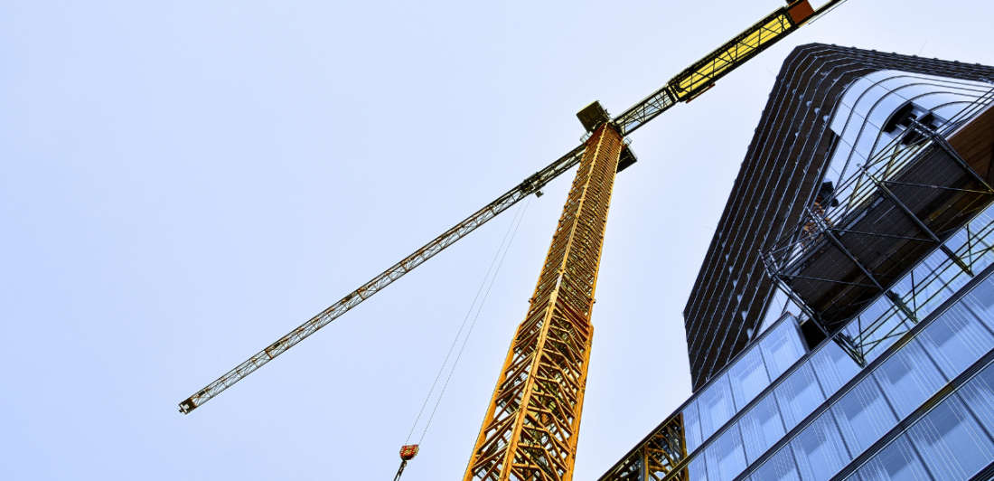 Image of building under construction and large crane