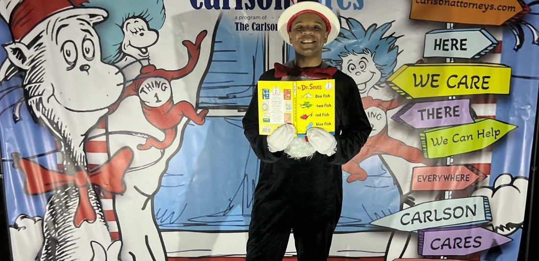 Personal Injury Attorney Michael Larrieux volunteers in a Cat in the Hat costume at free community movie night sponsored by Carlson Law Firm's charitable program, Carlson Cares