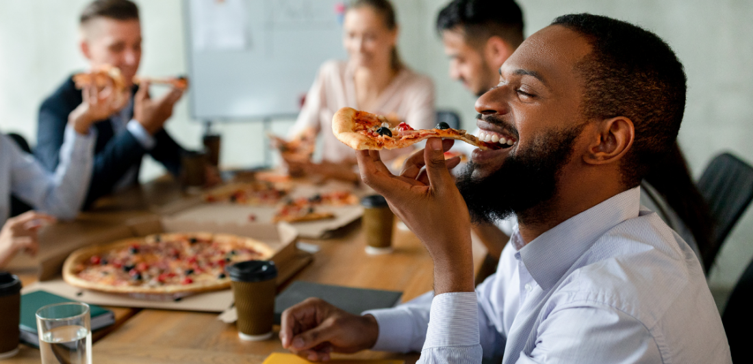 Meal-Break Image of happy people eating pizza at a table