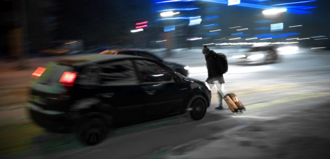 Image of pedestrian walking across the street