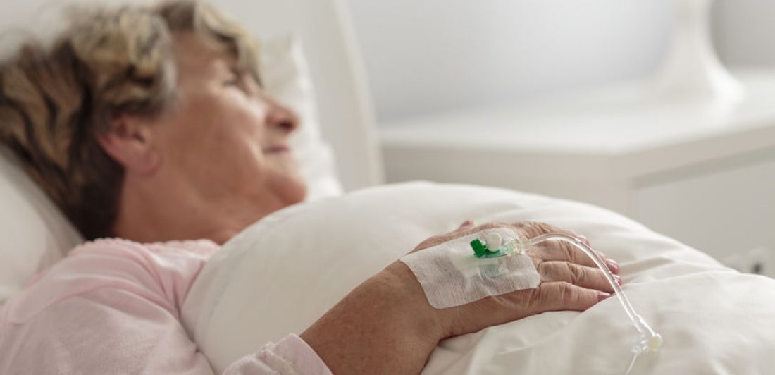 Woman with drip Image of elderly woman in a hospital bed with an IV