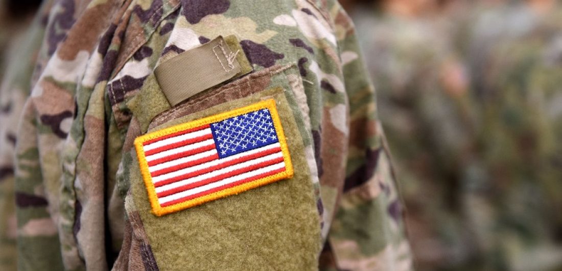 Veterans-Day-2022 Image of military person in uniform with a flag patch on the sleeve