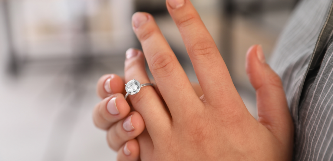 Woman taking ring off her left hand because of a divorce.