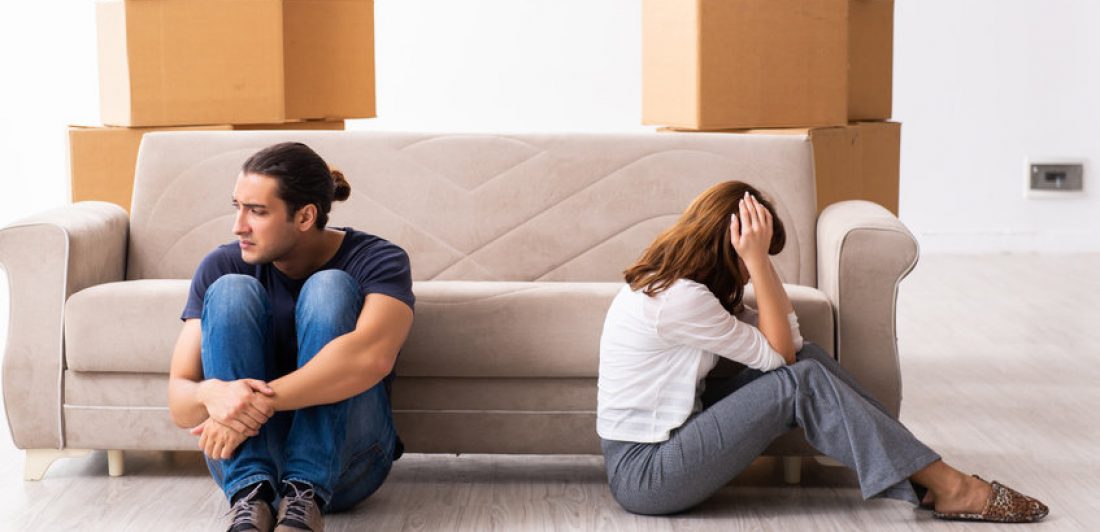 Young pair and many boxes in divorce settlement concept Divorce attorneys