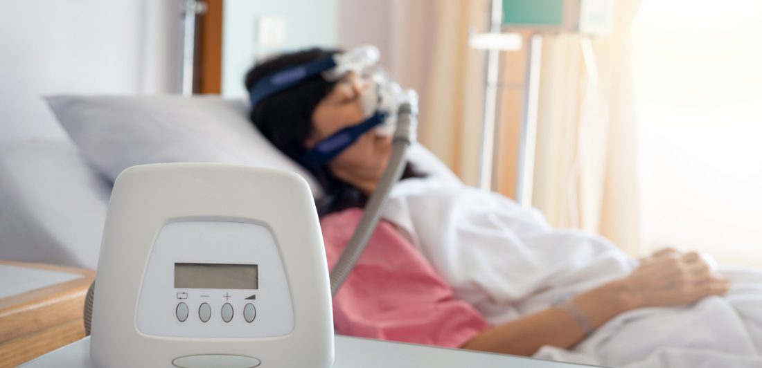 Obstructive sleep apnea therapy.Cpap machine is treating senior Image of a woman wearing a CPAP machine
