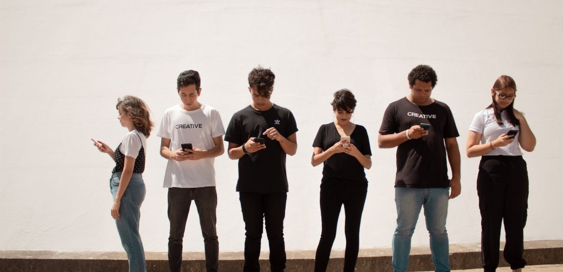 creative-christians-HN6uXG7GzTE-unsplash Image of people looking at their cell phones
