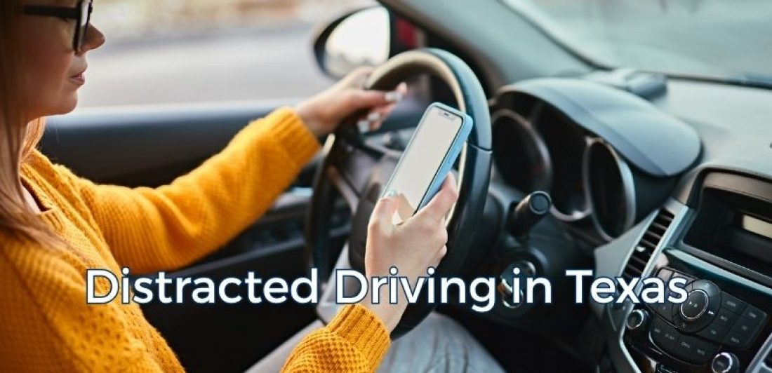 Driver using a cell phone while operating a vehicle in Texas traffic.
