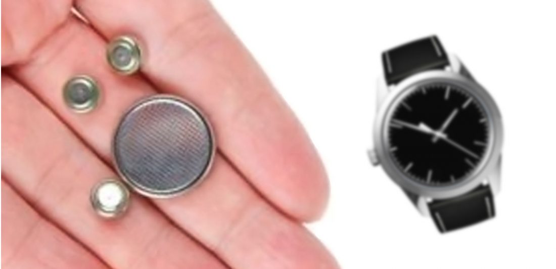 Image of button batteries in a hand with a watch nearby