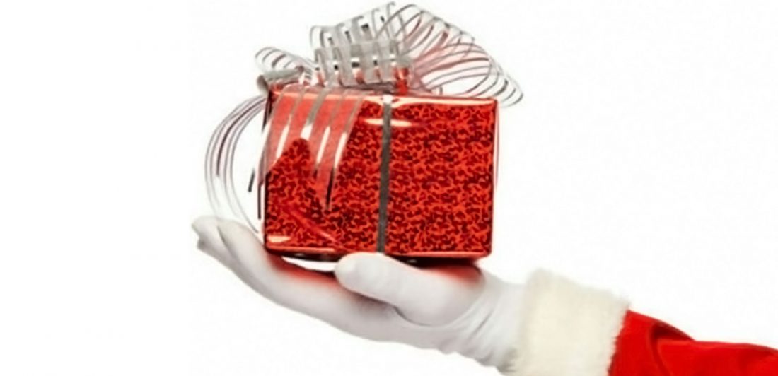 post-carlson-christmas-miracle Image of Santa Claus hand holding a red gift with a silver bow
