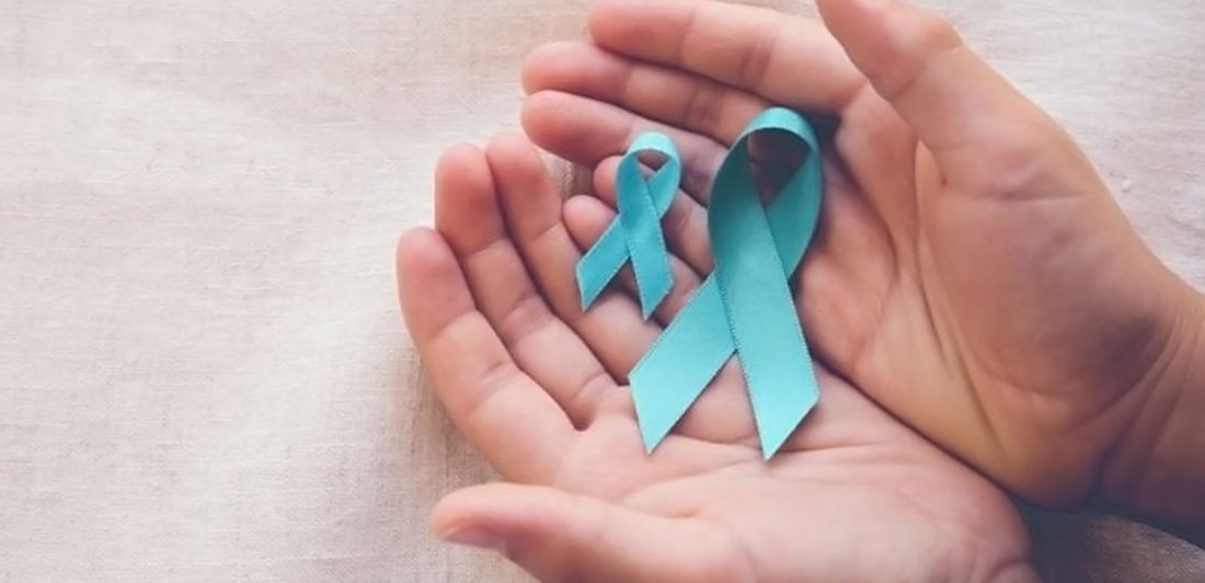 post-ovarian-cancer-causes Image of hands holding teal ovarian cancer awareness ribbons