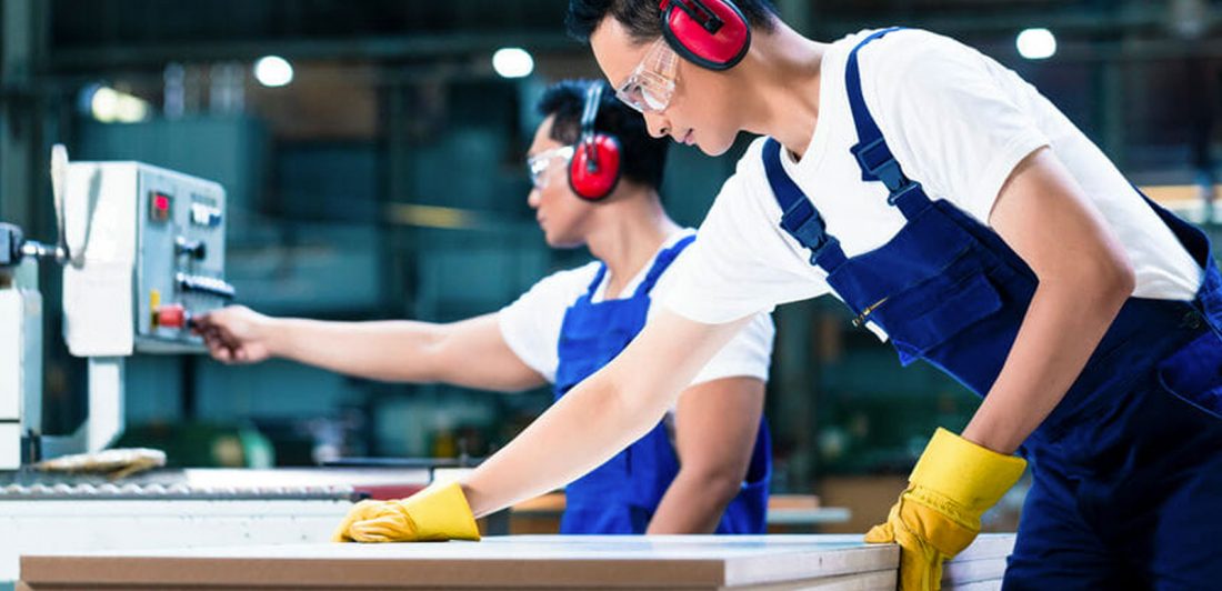 post-prevent-workplace-injuries Image of workers in a factory wearing protective gear