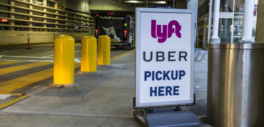 post-ridesharing-safety Lyft and Uber sign outside of an airport at pickup area