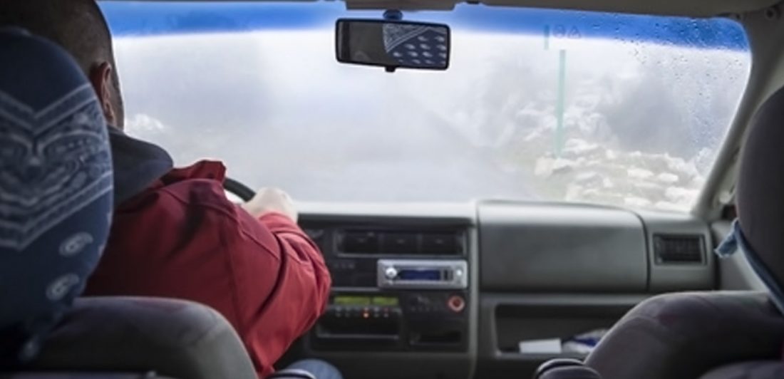 post-winter-driving-preparation Image of person driving vehicle in winter weather conditions