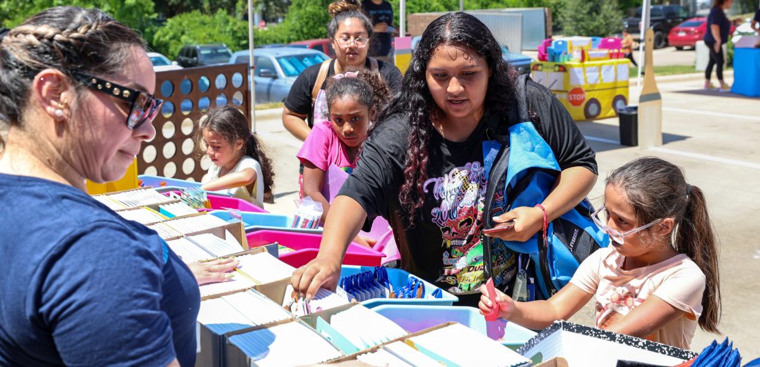 Students select free school supplies during the Carlson Cares San Marcos Backpack Giveaway.