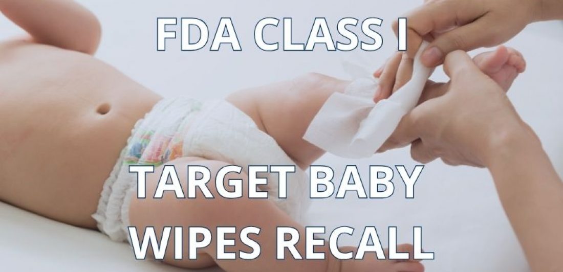 Caregiver using a baby wipe on an infant representing the Target Up & Up baby wipes recall.