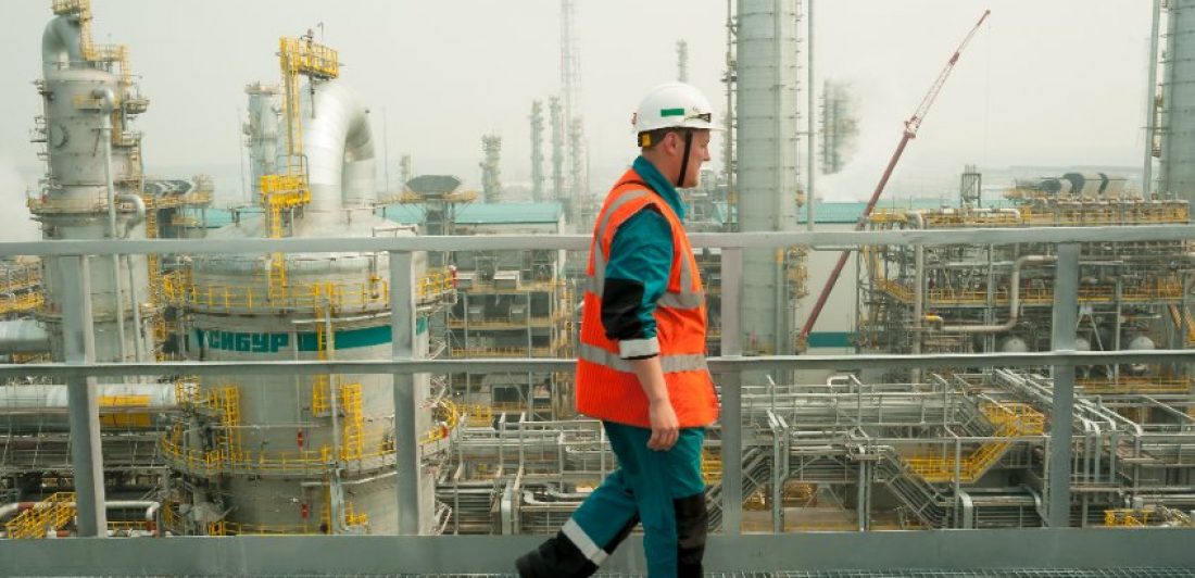 workplace-safety Image of man in safety gear walking at a chemical plant